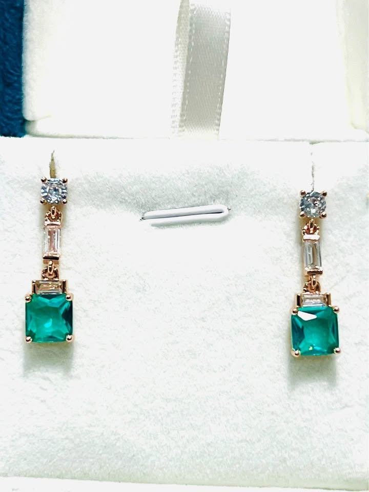 Pair of exquisite sterling silver, rose gold-filled earrings featuring emerald-cut green topaz and clear accents.