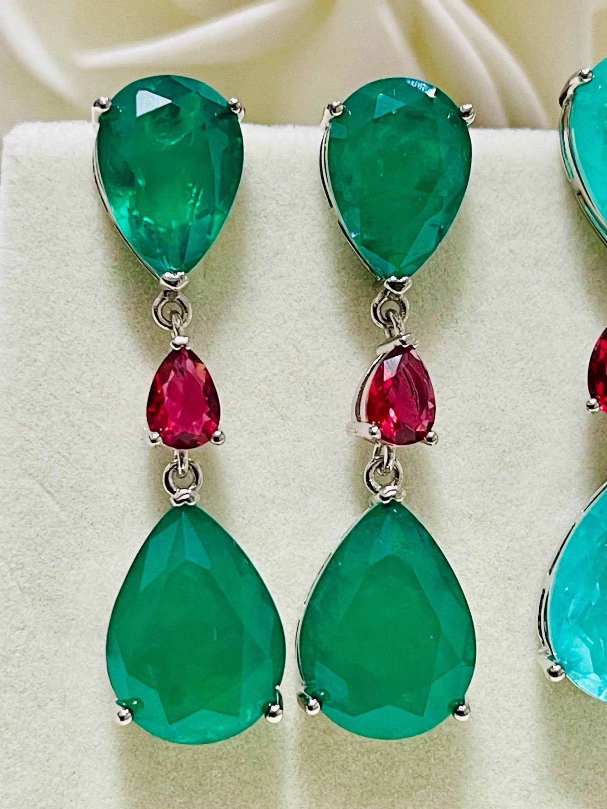 Detailed view of emerald doublet drop earrings, highlighting the rich green color and design.