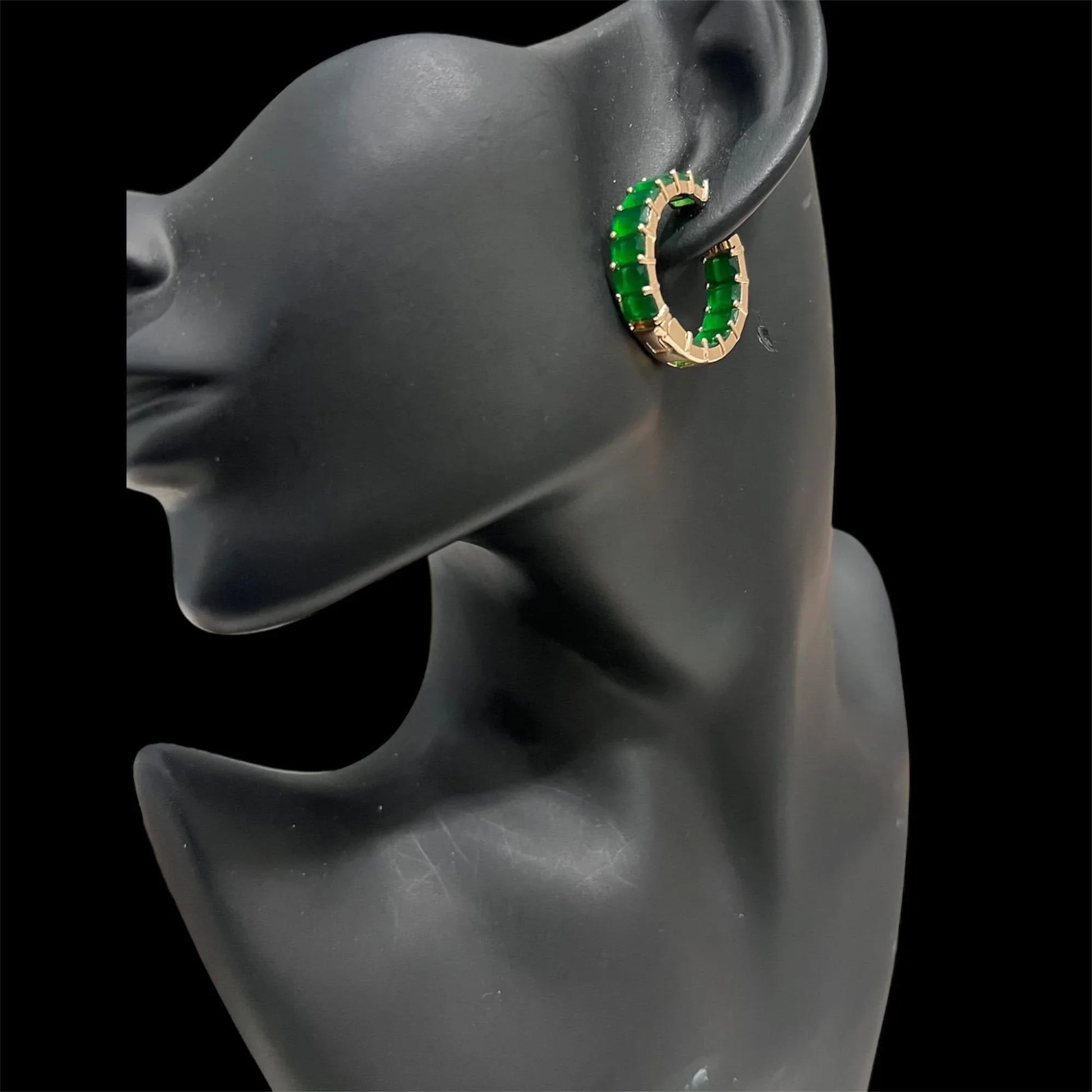 Green matrix emerald hoop earring with gold-tone setting worn on a black mannequin ear.