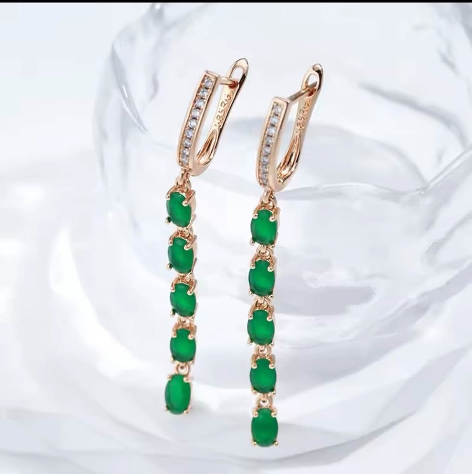 A pair of elegant 14K 585RG emerald and diamond long dangle earrings on a clear glass background.