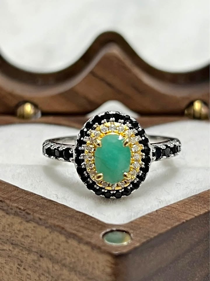 Genuine oval emerald ring with a black spinel halo, two-toned gold/silver sterling silver.