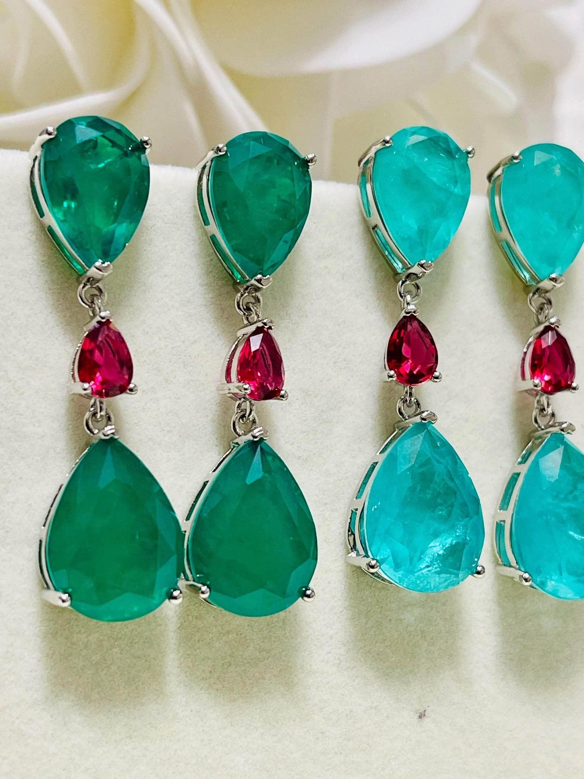 Close-up of both emerald and Paraiba doublet drop earrings, showcasing color and craftsmanship.