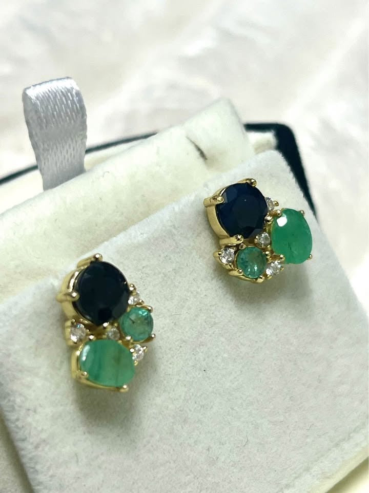 Stunning Colombian emerald and sapphire stud earrings in a white gift box, ready for gifting.