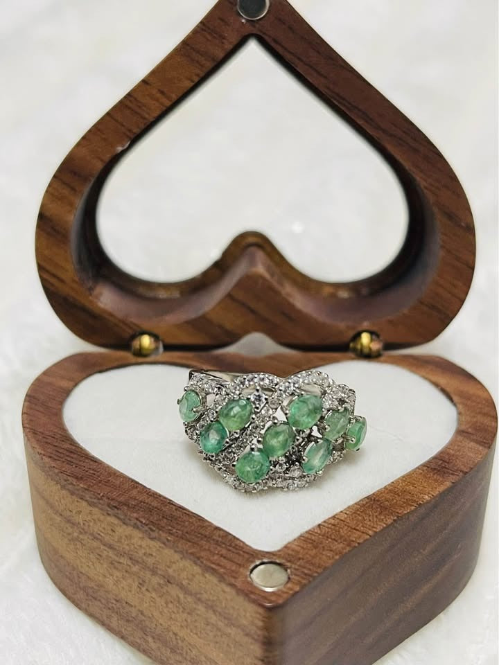 Elegant 925S silver emerald statement ring displayed in a heart-shaped wooden box, highlighting its intricate design.