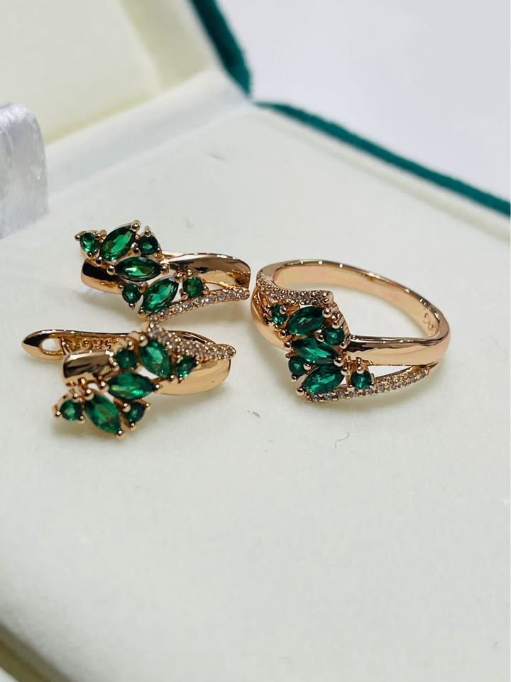 Matching 14k rolled gold set including earrings and a ring, adorned with marquise-cut green stones.