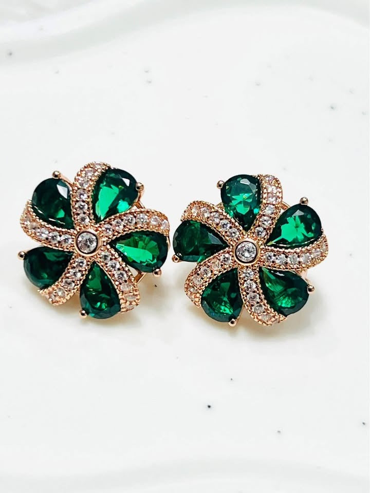 Stunning emerald green topaz and diamond-accented floral stud earrings in rose gold.