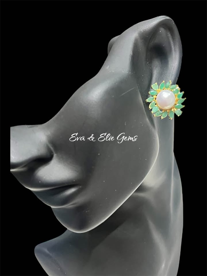 Eva & Elie Gems natural South Sea pearl and emerald stud earring on a mannequin ear.