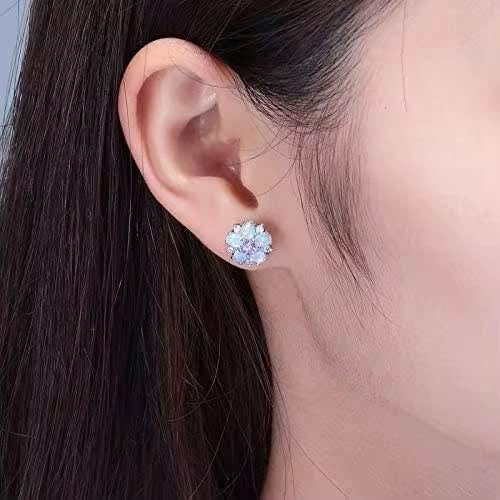 Fire opal and amethyst flower stud earring worn on an ear, demonstrating its size and how it compliments an outfit.