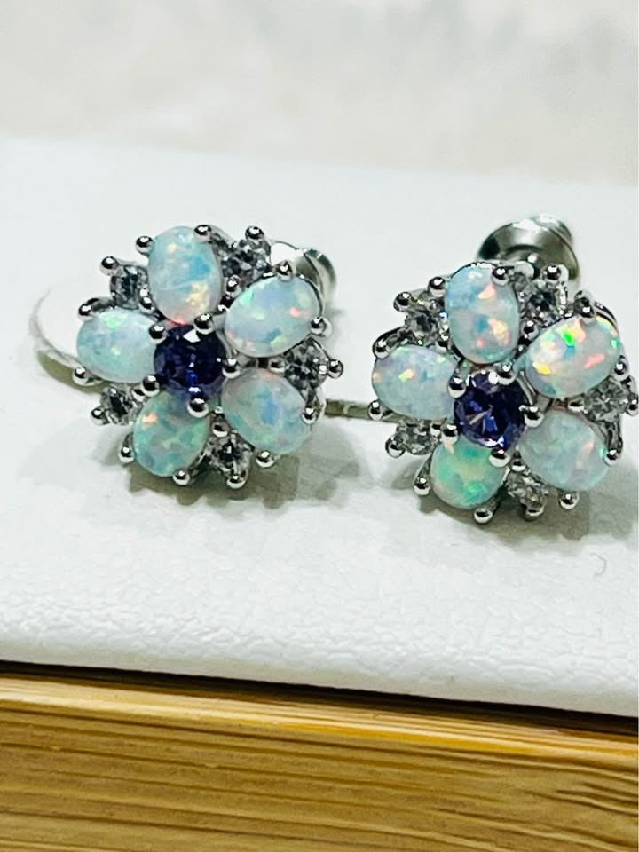 Close-up of fire opal and amethyst floral stud earrings, showcasing the intricate gemstone arrangement and sparkle.