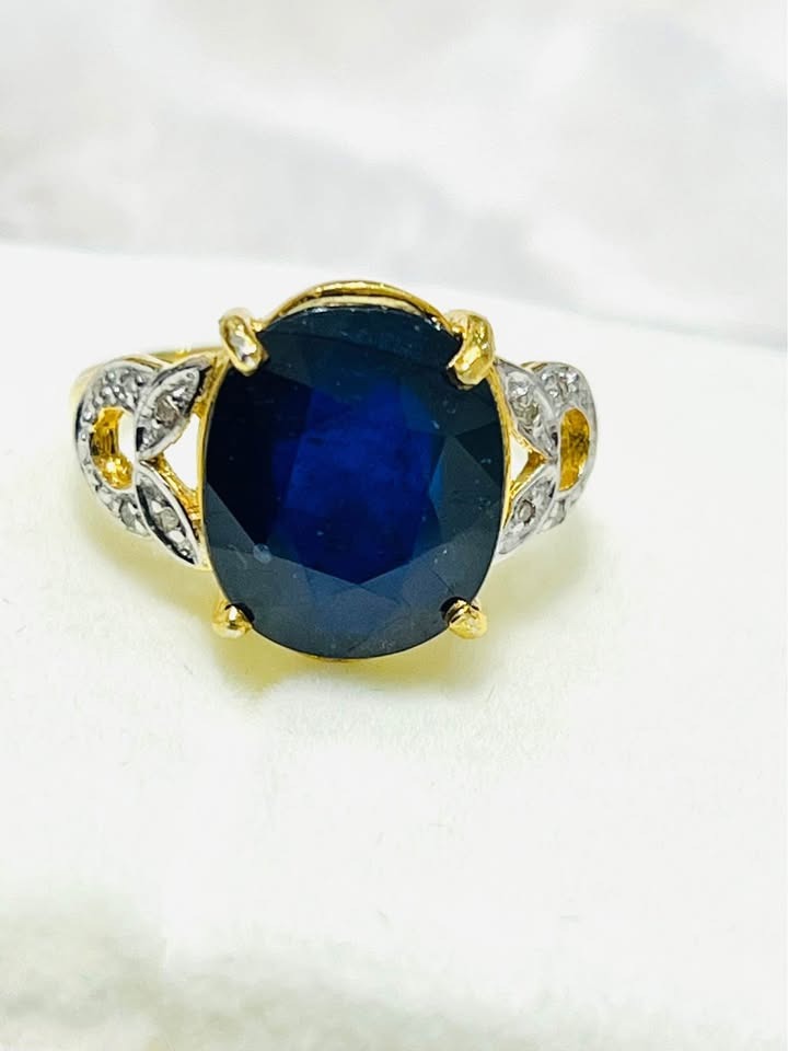 Striking front view of a 6 CTW natural sapphire ring with genuine diamonds and gold-plated sterling silver.