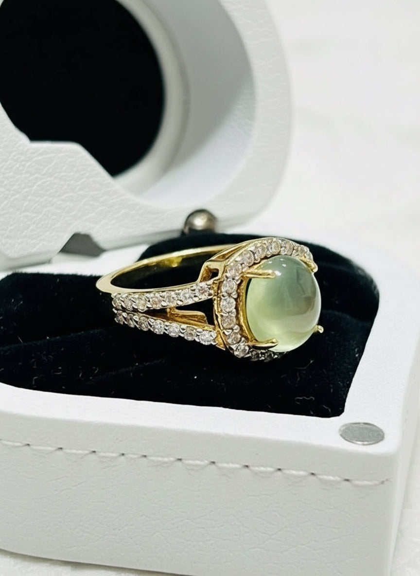 Side view of a genuine prehnite and diamond ring, 14k gold plated sterling silver, in a wooden box.