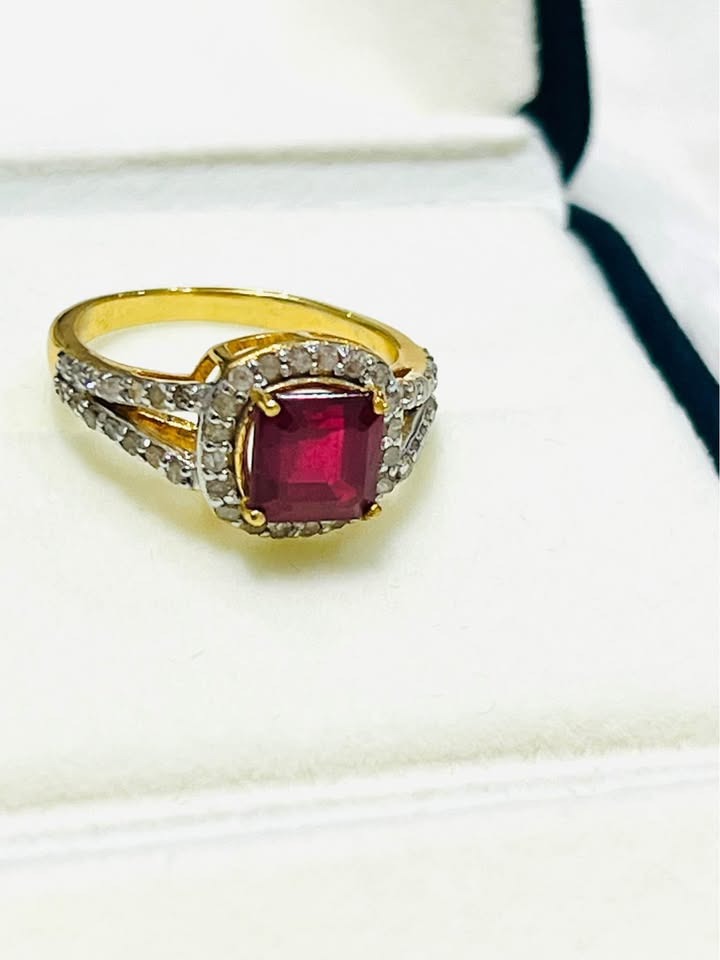 Beautiful genuine ruby and natural diamond ring in gold, showcased in an open white jewelry box.