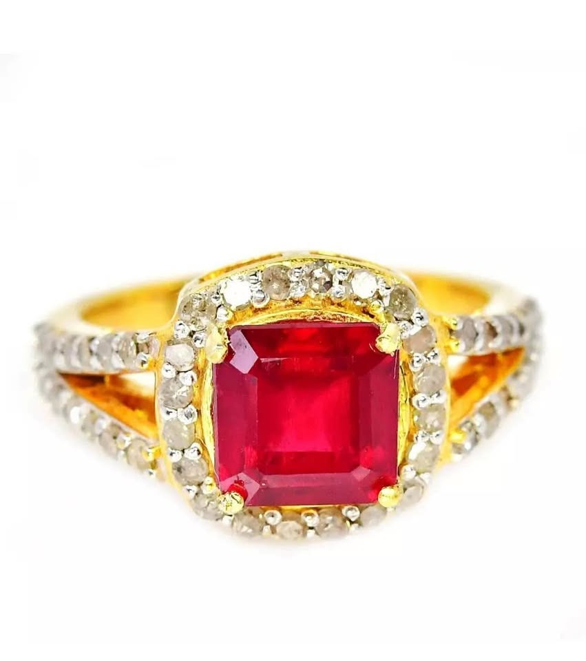 Stunning genuine ruby and natural diamond ring in gold with halo, top view on white.