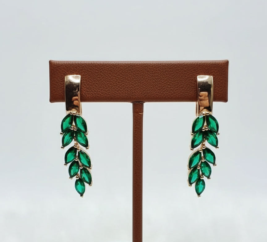 14k gold-filled dangle earrings with a delicate leaf design, featuring marquise-cut green topaz gemstones.