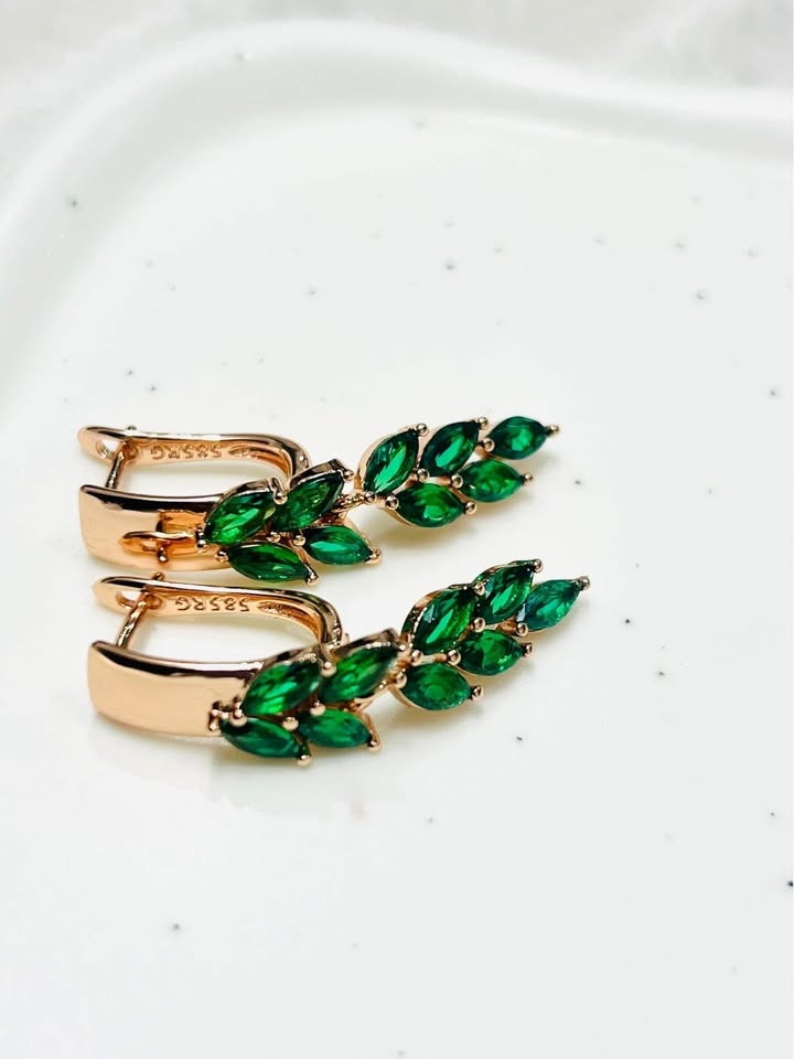 Top-angle view of 14k gold-filled earrings, showcasing a leaf-like cluster of bright green topaz stones.