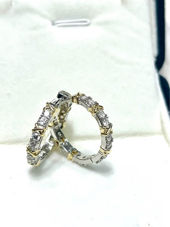  Pair of gold plated silver XOXO hoop earrings with cubic zirconia in a white jewelry box.