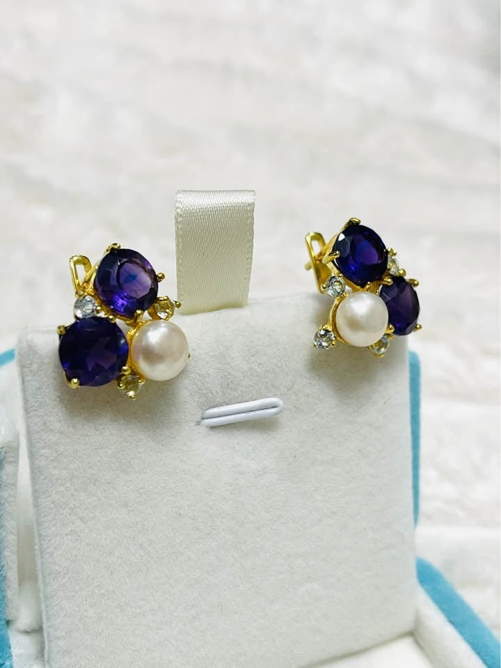 Stunning gold-tone sterling silver earrings featuring natural amethyst and a dangling pearl, side view.