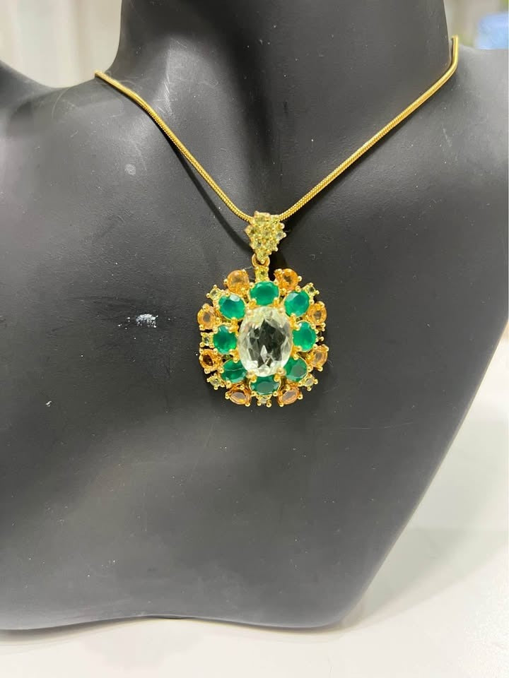 A stunning pendant necklace with green amethyst, green agate, and yellow sapphires, displayed on a mannequin.