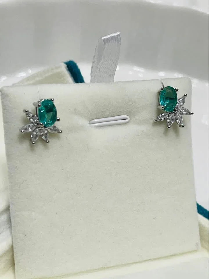 Green paraiba tourmaline stud earrings set against a clean white display card. Perfect for a delicate and elegant look.