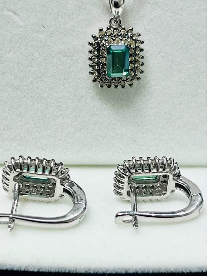  Detailed view of green tourmaline and diamond earrings (backs) and pendant, showcasing the settings.