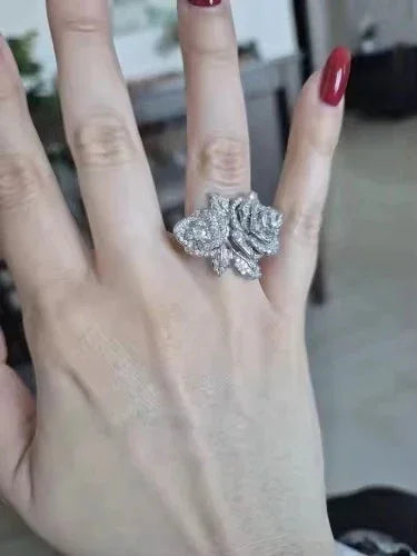  Hand showcasing a dazzling rose-shaped gold vermeil CZ statement ring, perfect for elegant style.