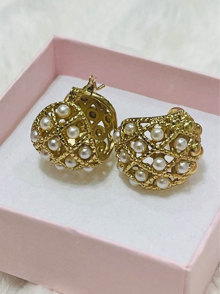 Side view of a pair of handcrafted 18k gold-filled hoop earrings, with a continuous line of seed pearls.