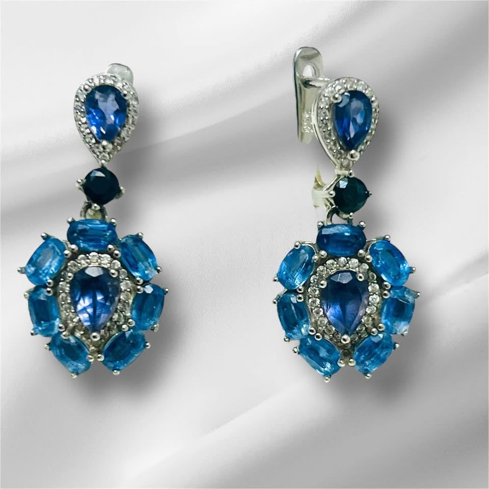  Exquisite handmade dangle earrings featuring deep blue sapphires and vibrant iolite gems on a white display.