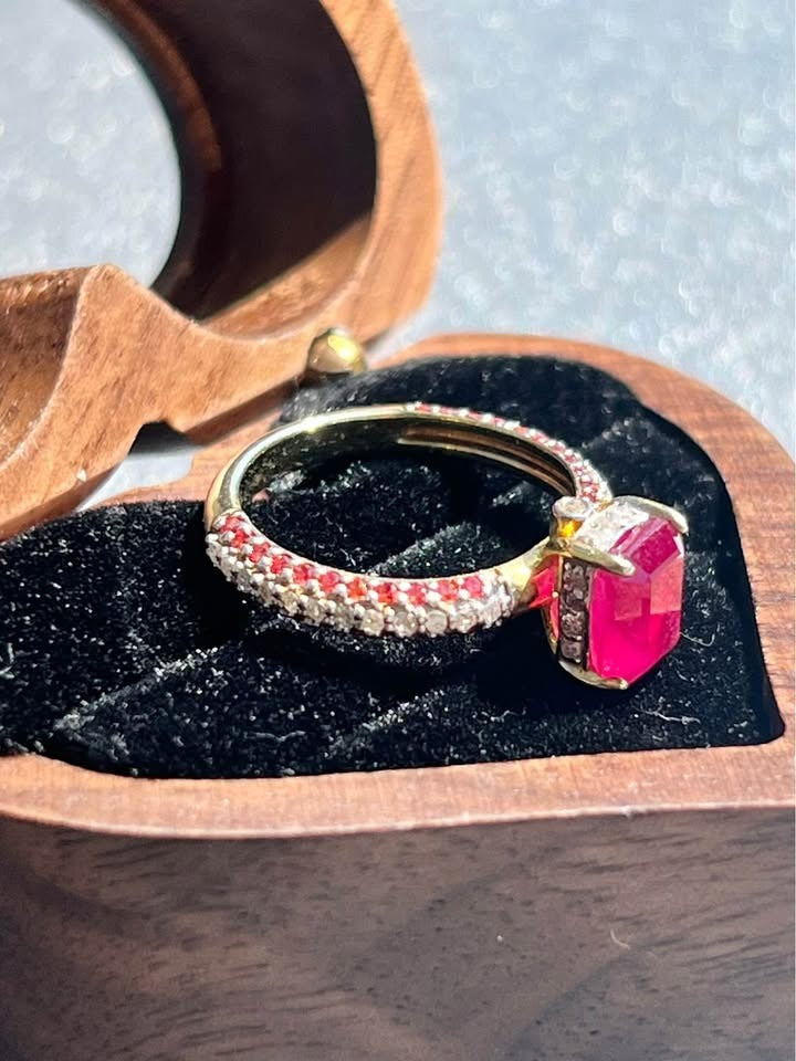 Natural ruby and diamond ring in a heart-shaped wooden box.