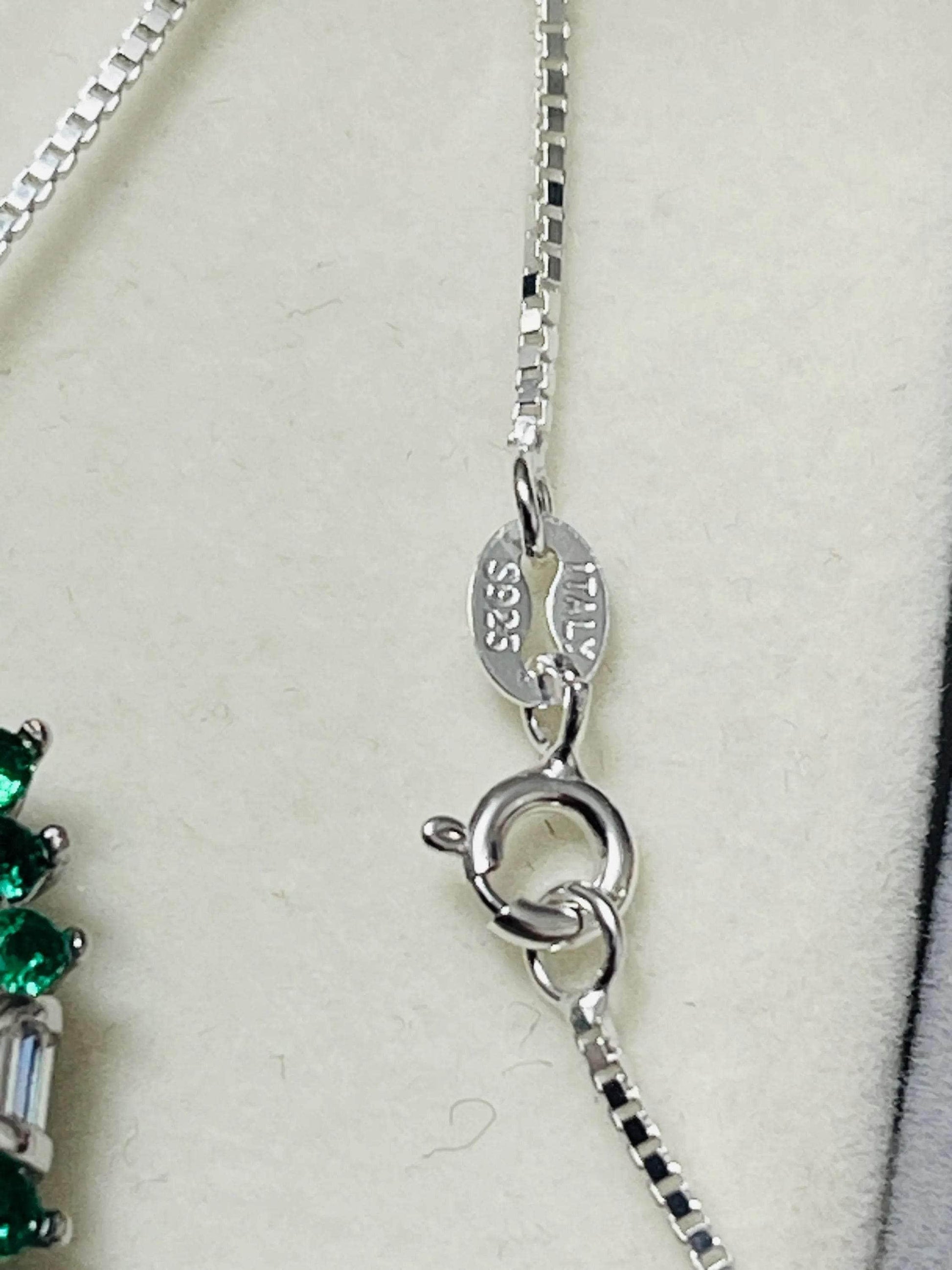 Close-up of the "S925 Italy" hallmark on the clasp of an Italian sterling silver necklace, authenticating quality.