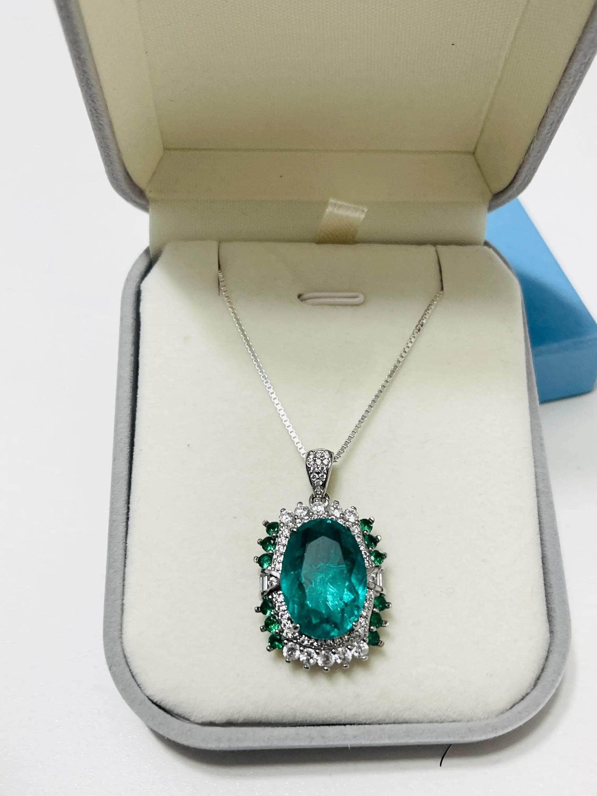Stunning lab-created emerald pendant necklace with clear accent stones on an Italian sterling silver chain, in a gift box.