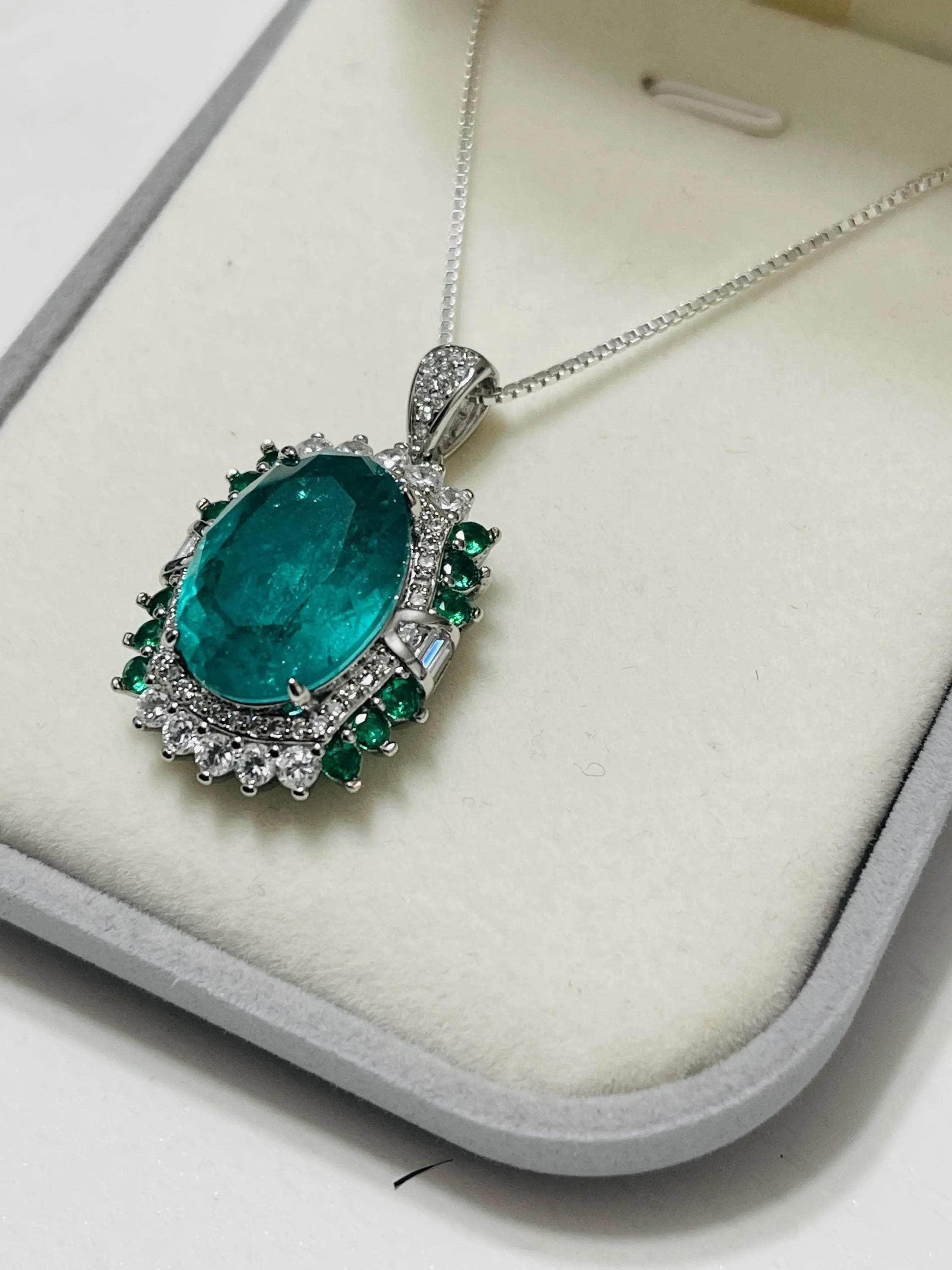 Side view of a lab-created emerald pendant necklace in Italian sterling silver, highlighting its elegant setting.

