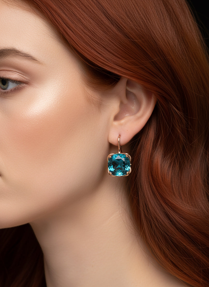 Front view of a 14K rose gold London Blue Topaz earring displayed on a mannequin.