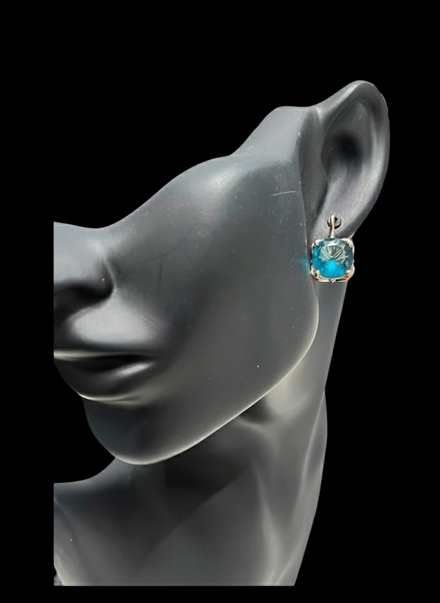 14K rose gold London Blue Topaz earring on a mannequin, side profile.