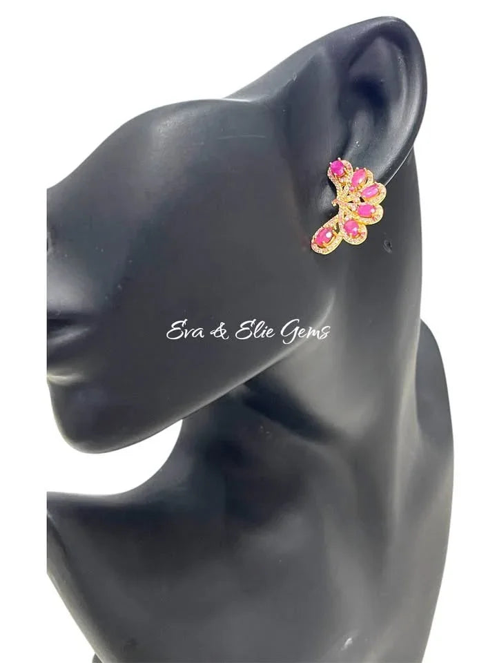 A mannequin wearing genuine 925 sterling silver ear climbers. The design features a mix of pink rubies and sapphires.