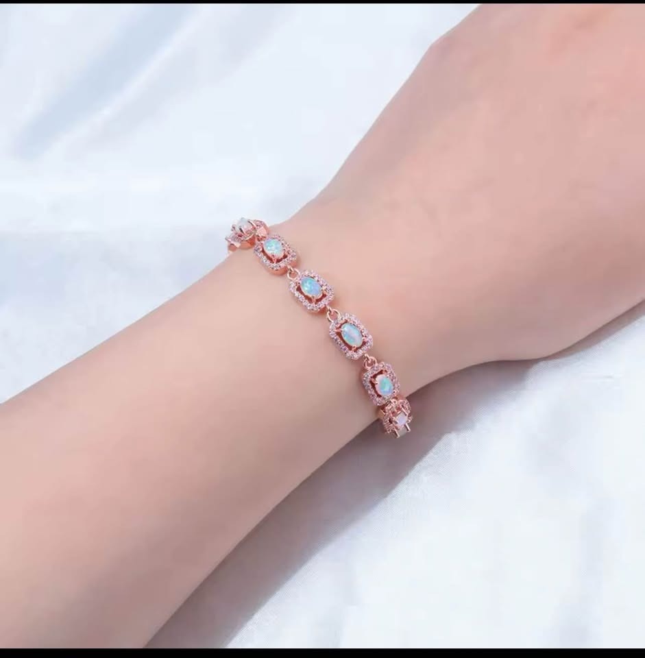 Close-up of a person wearing a chic 14K gold-filled onyx dove earring, showing its delicate dangle.