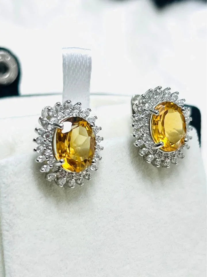 Natural citrine oval halo earrings in a jewelry box, highlighting golden citrine.