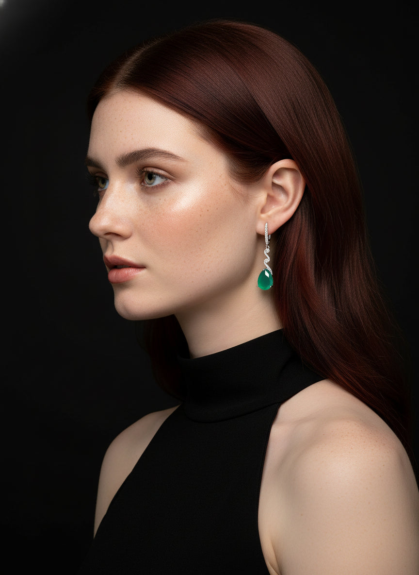 A mannequin modeling sterling silver dangle earrings with beautiful green agate teardrop stones.