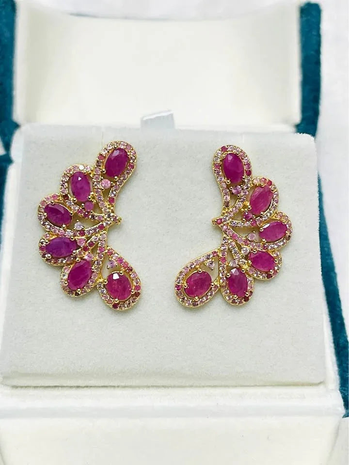  A pair of genuine 925 sterling silver ear climbers. Features natural pink rubies and sapphires in an elegant, curved design.