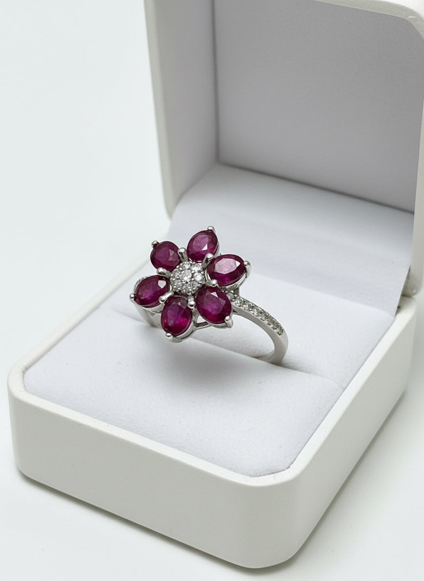 Top view of a beautiful natural ruby cluster ring, set in a floral design.