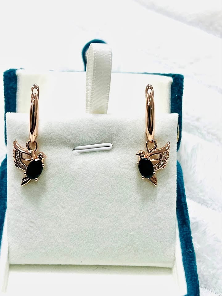 Stunning 14K gold-filled onyx dove earrings with pave details, prominently displayed in a white jewelry box.