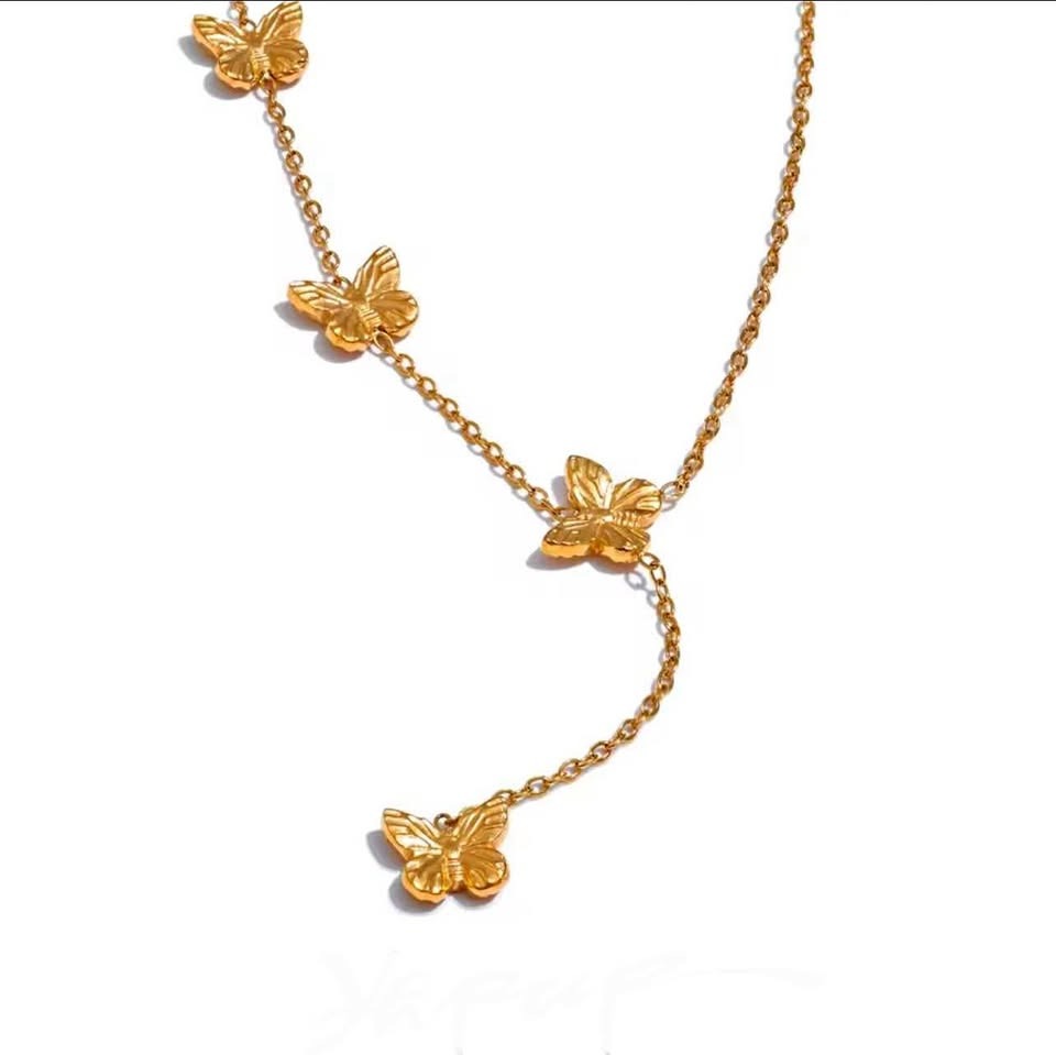 18k gold vermeil Papillon D'Or necklace with multiple butterfly accents on a white background.