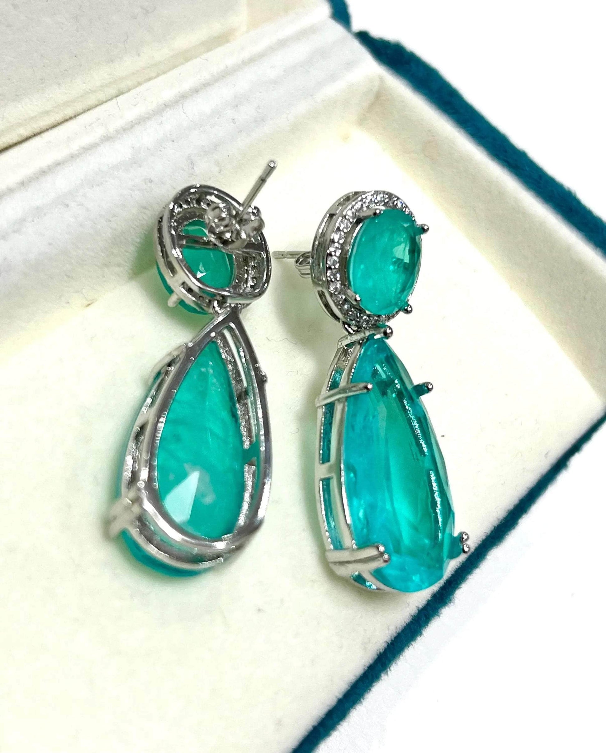 Back view of Paraiba tourmaline drop earrings, showcasing the intricate silver setting and closure.