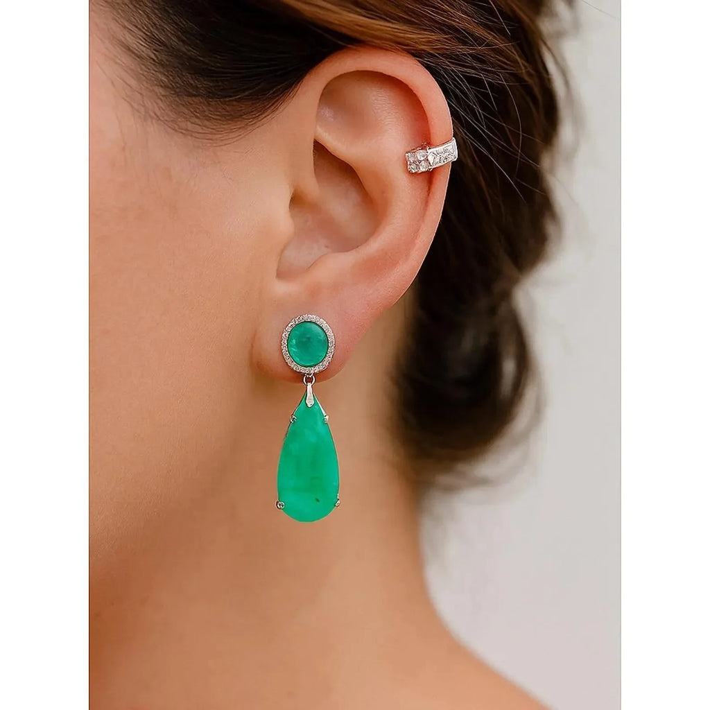  Elegant green Paraiba tourmaline drop earring worn by a model, highlighting its beautiful dangle and color.