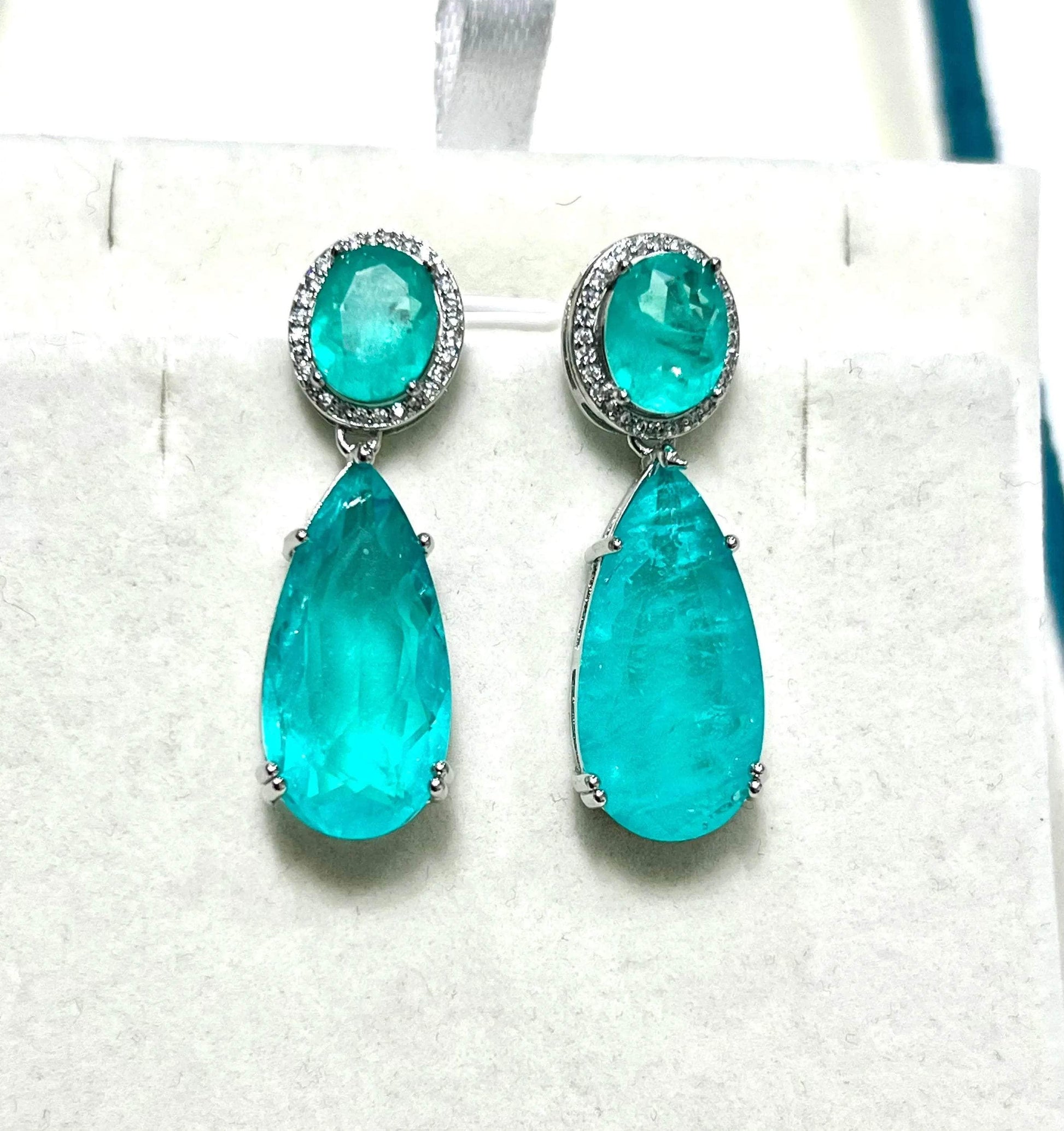 Stunning pear-shaped Paraiba tourmaline drop earrings with diamond halo studs, elegant design.