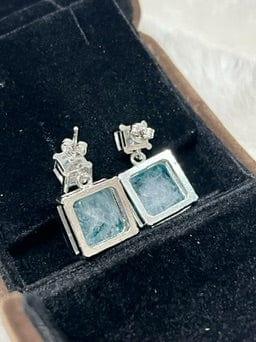 Back view of emerald-cut Paraiba tourmaline earrings, revealing the secure settings and craftsmanship.