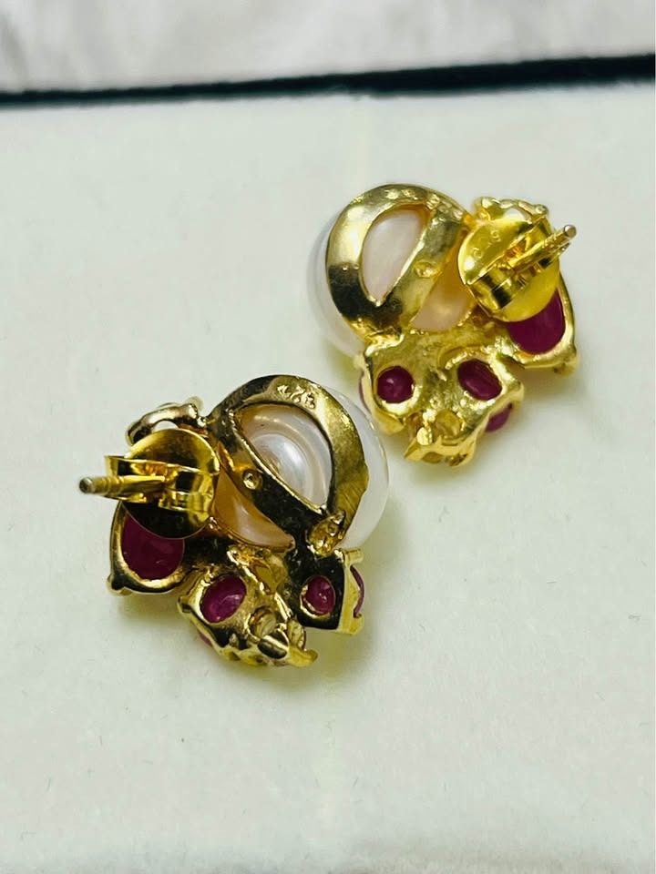  Back view of artisan South Sea pearl earrings, revealing ruby and white topaz settings and secure posts.