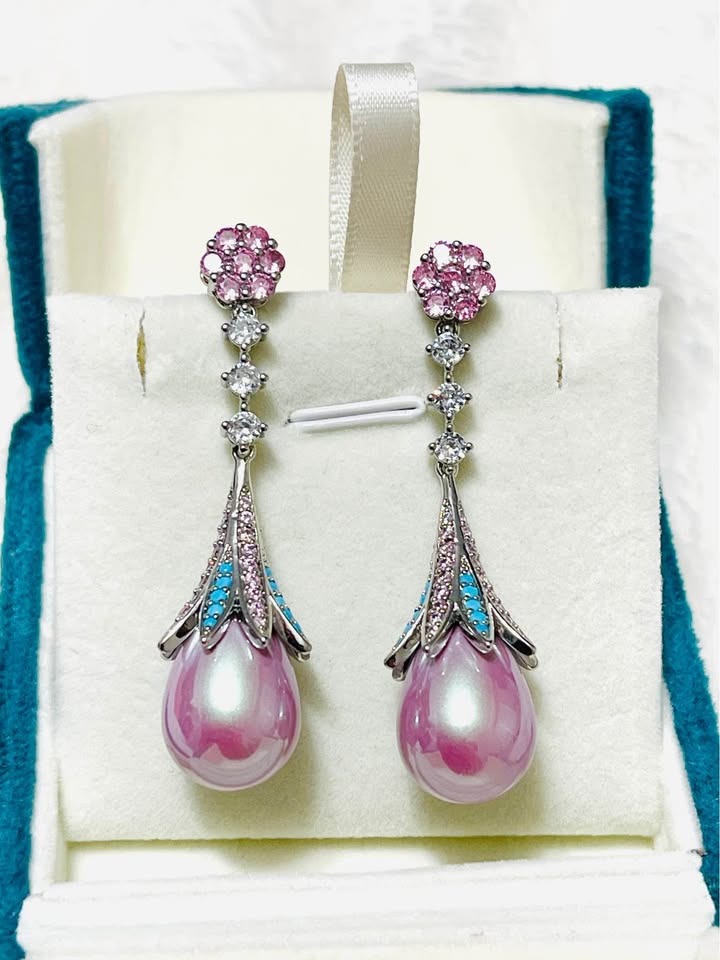  Elegant pink pearl drop earrings with turquoise and pink cubic zirconia accents, presented in a jewelry box.