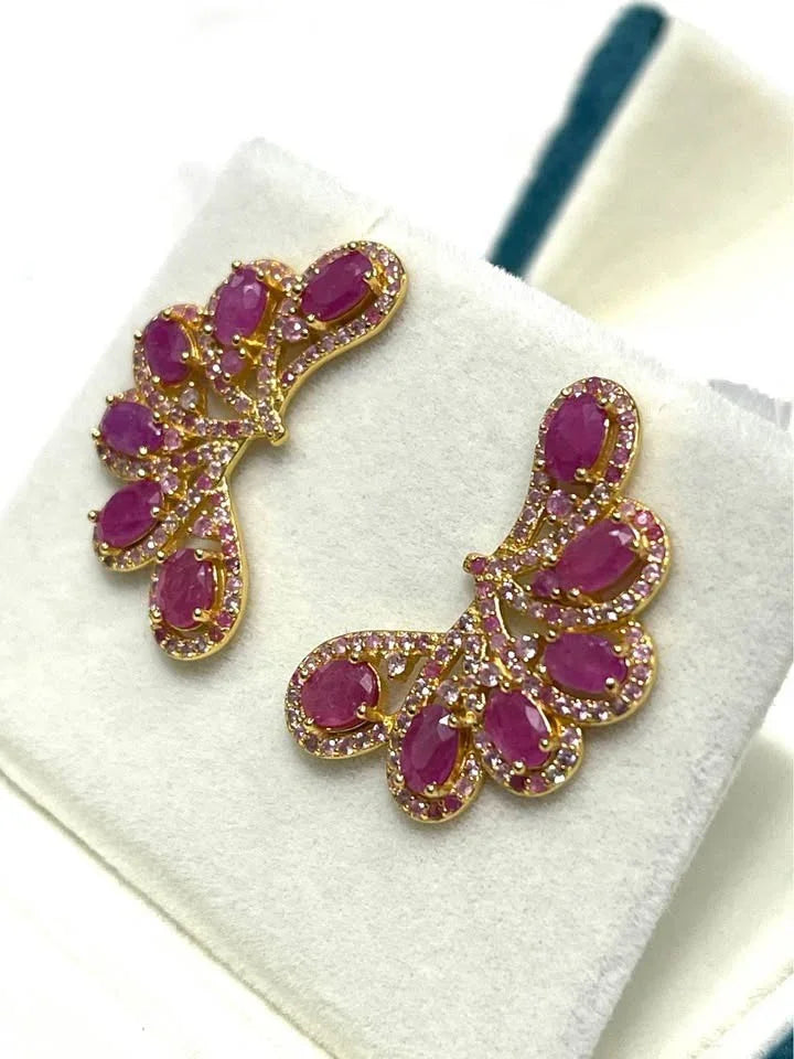 A pair of pink ruby and pink sapphire ear climbers. The genuine 925 sterling silver earrings have a striking, elegant design.