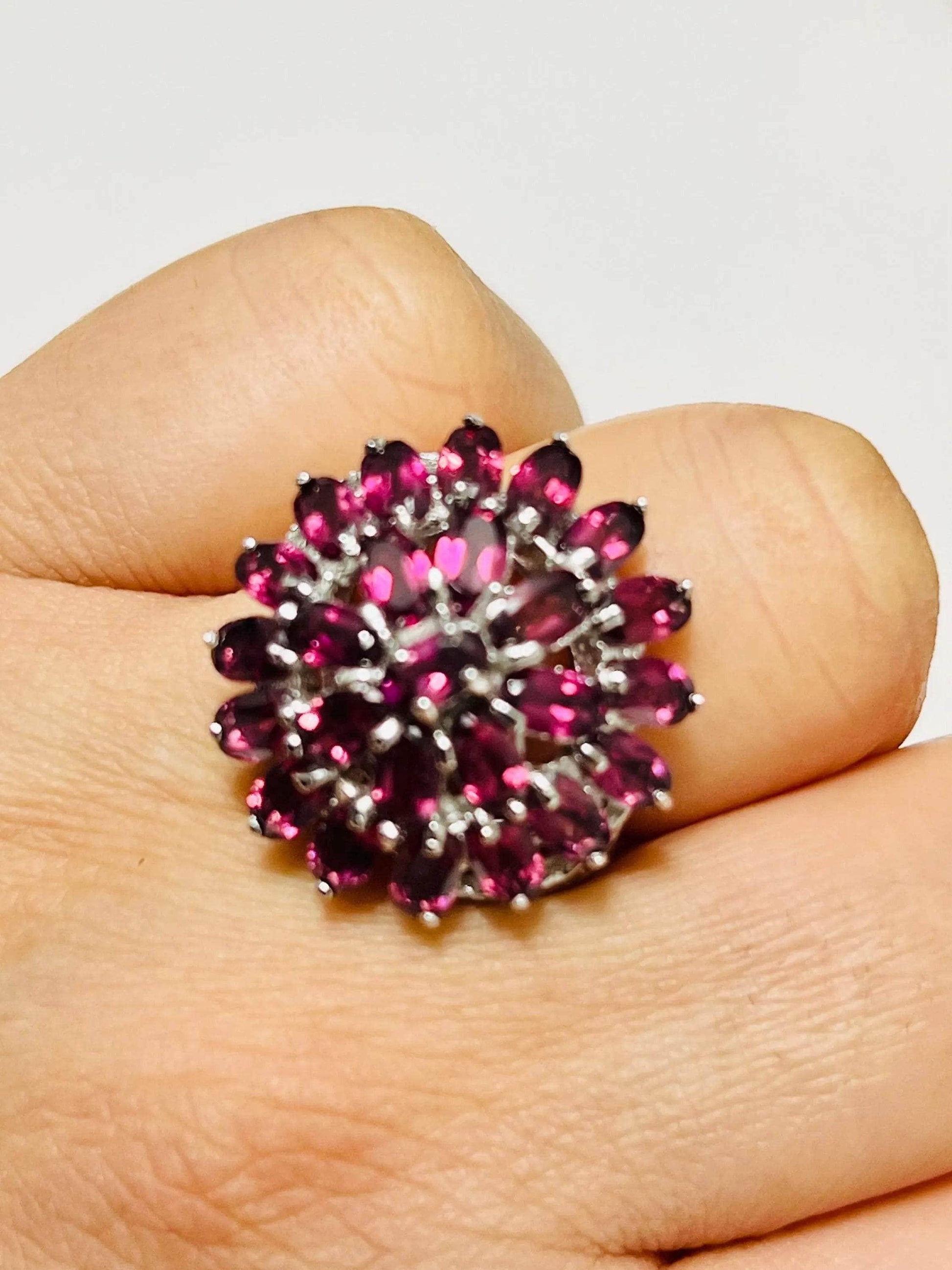 Bochic vintage rhodolite garnet cluster ring worn on a finger, highlighting its striking presence and design.