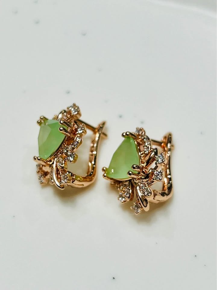 Frontal view of stunning 14k rolled gold earrings, each holding a luminous green prehnite gem with brilliant CZ highlights.